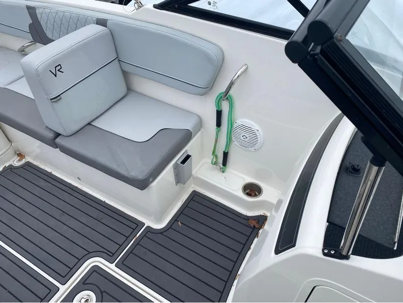 Slide: The Image of 2023 Bayliner VR4 Bowrider interior with gray seating and black flooring. - 11