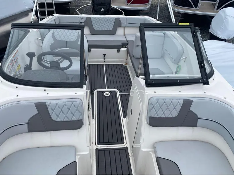 Slide: The Image of 2023 Bayliner VR4 Bowrider interior with gray seating and black flooring. - 12