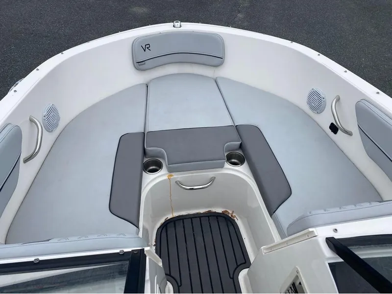Slide: The Image of 2023 Bayliner VR4 Bowrider boat interior with gray seating and cup holders. - 4