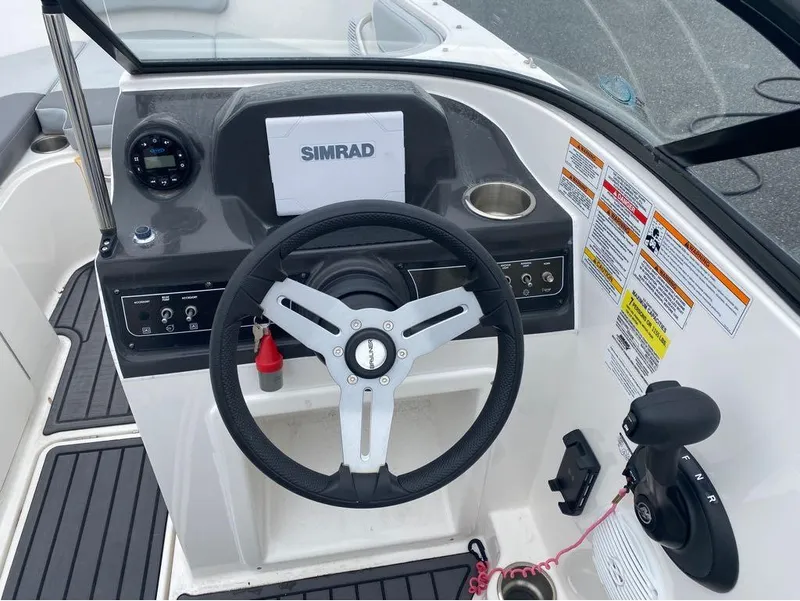 Slide: The Image of 2023 Bayliner VR4 Bowrider dashboard with steering wheel and Simrad display. - 5