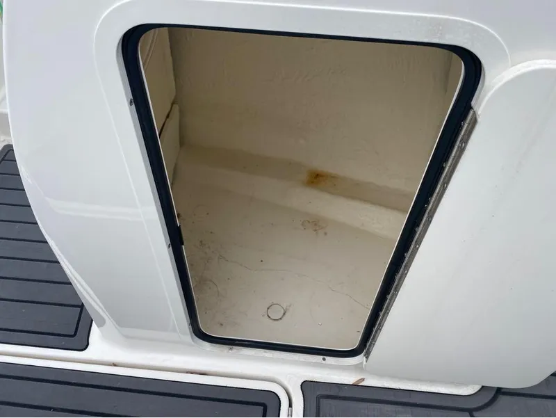Slide: The Image of 2023 Bayliner VR4 Bowrider storage compartment with open hatch, showcasing interior space. - 7