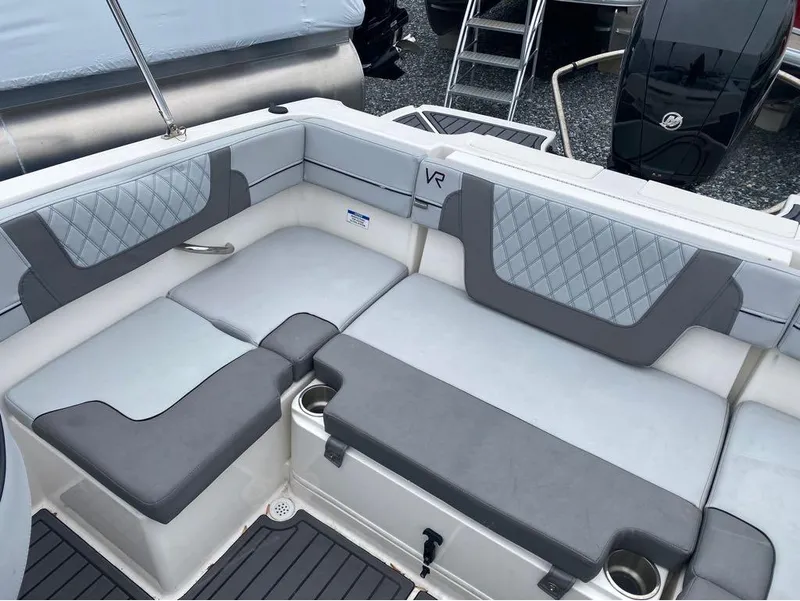 Slide: The Image of 2023 Bayliner VR4 Bowrider interior with gray cushioned seating and cup holders. - 9