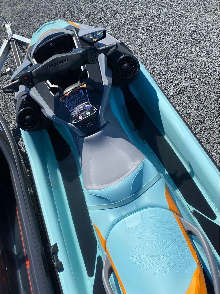 Slide: The Image of 2022 Sea-Doo RXT-X 300 Premium, turquoise and orange, top view on gravel. - 3