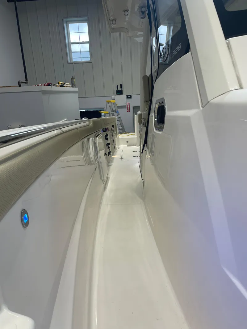 Slide: The Image of 2019 Pursuit S 328 Sport boat interior, showcasing sleek white design and modern features. - 10