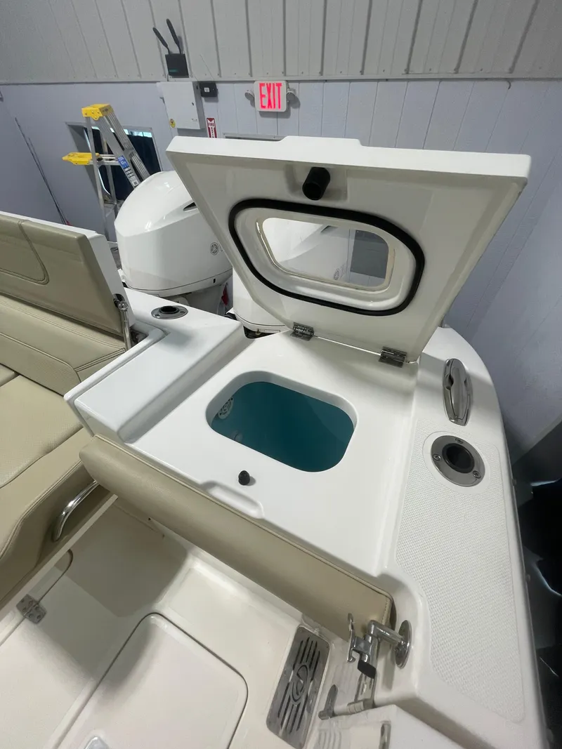 Slide: The Image of 2019 Pursuit S 328 Sport boat interior with open storage compartment. - 21