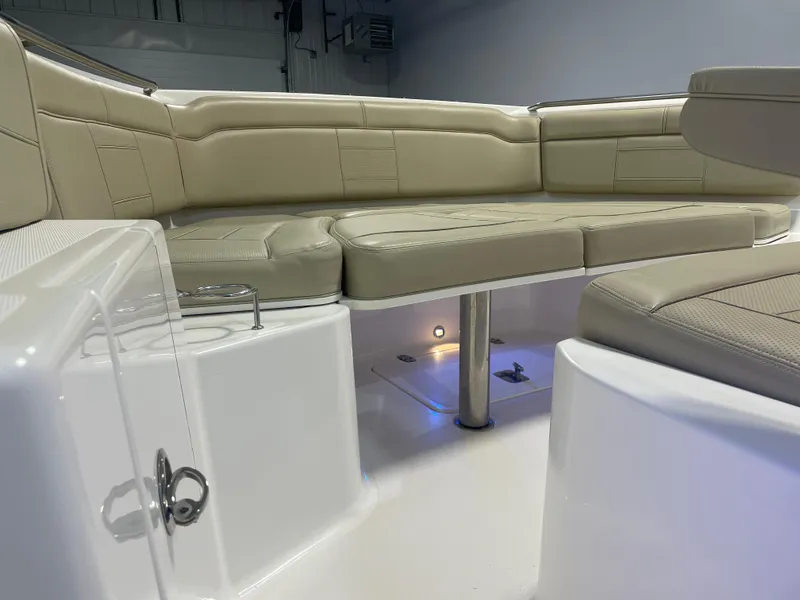 Slide: The Image of 2019 Pursuit S 328 Sport boat interior with beige seating and ambient lighting. - 24