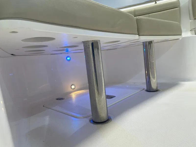 Slide: The Image of 2019 Pursuit S 328 Sport boat seating area with blue LED lighting. - 27