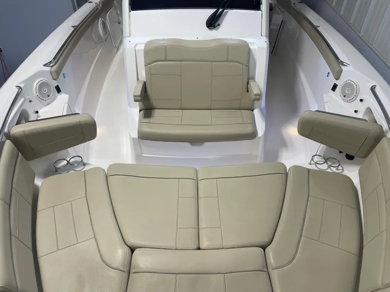 Slide: The Image of 2019 Pursuit S 328 Sport boat interior with beige seating and cup holders. - 29