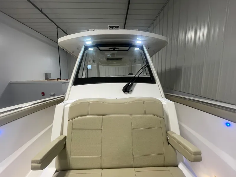 Slide: The Image of 2019 Pursuit S 328 Sport boat interior with beige seating and modern design. - 30