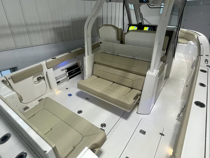 Slide: The Image of 2019 Pursuit S 328 Sport boat interior with beige seating and modern design. - 35