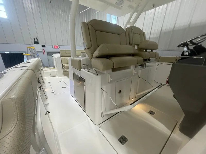 Slide: The Image of 2019 Pursuit S 328 Sport boat interior with beige seating and modern controls. - 36