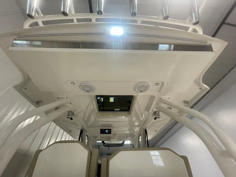 Slide: The Image of 2019 Pursuit S 328 Sport boat interior with overhead lighting and rod holders. - 37