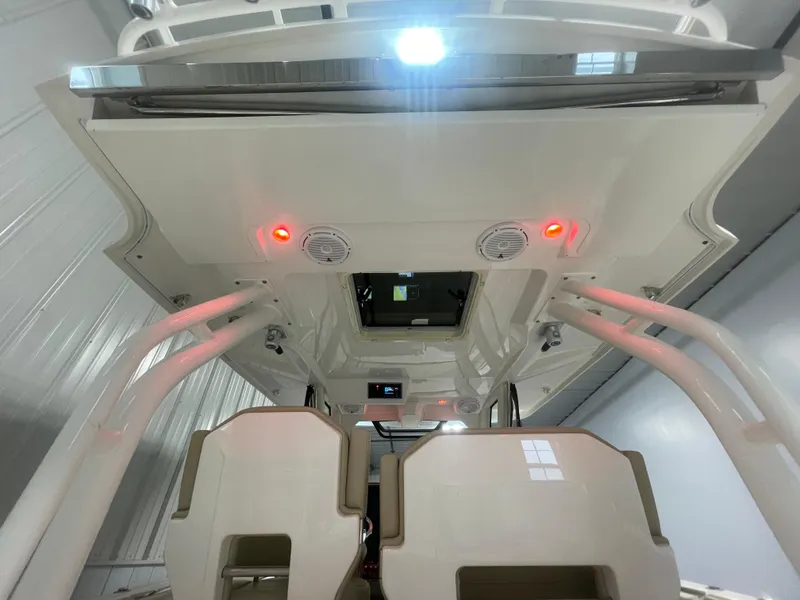 Slide: The Image of 2019 Pursuit S 328 Sport boat interior with red lights and seating. - 38