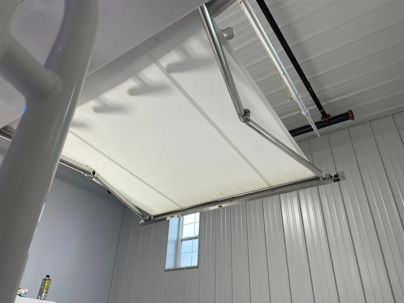 Slide: The Image of 2019 Pursuit S 328 Sport boat canopy in a metal-walled garage. - 39