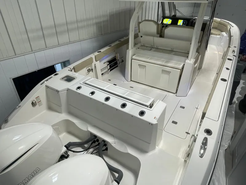 Slide: The Image of 2019 Pursuit S 328 Sport boat interior with seating and dual Yamaha engines. - 40