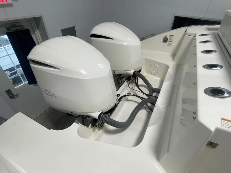 Slide: The Image of 2019 Pursuit S 328 Sport boat with dual Yamaha outboard engines in a showroom. - 42