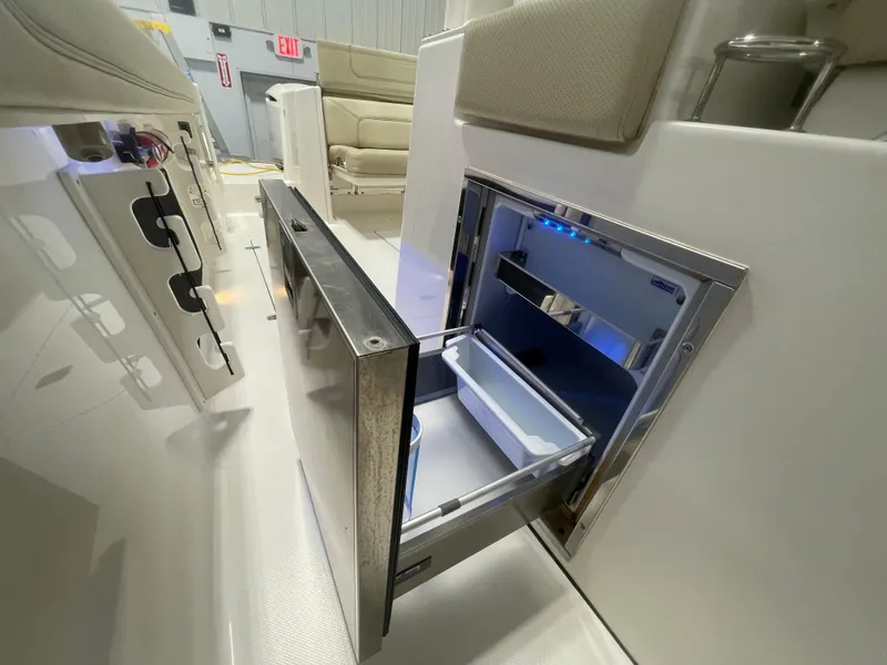 Slide: The Image of 2019 Pursuit S 328 Sport boat with open stainless steel drawer refrigerator. - 44