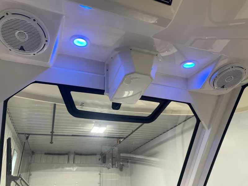 Slide: The Image of 2019 Pursuit S 328 Sport boat interior with blue LED lights and speakers. - 48