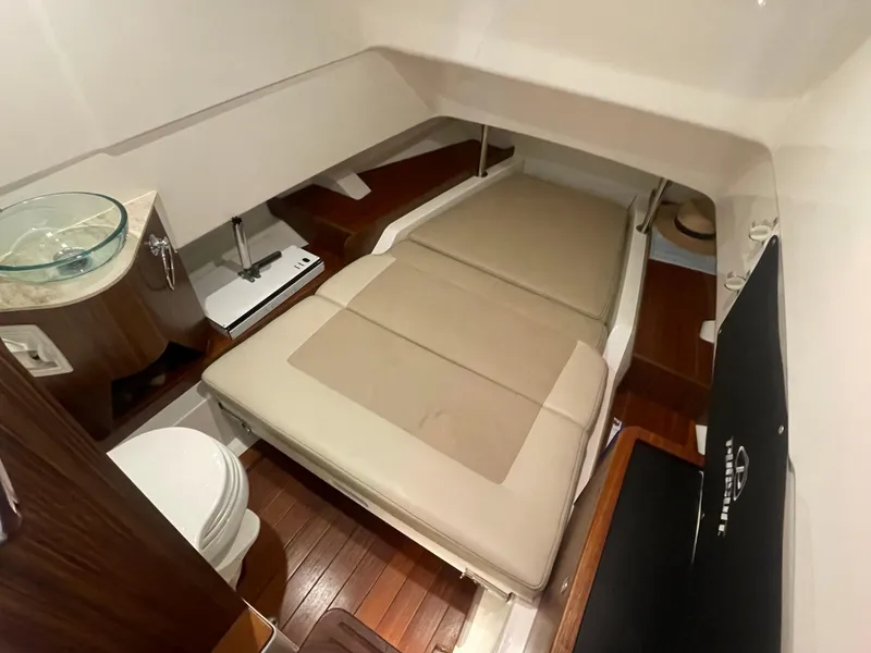 Slide: The Image of 2019 Pursuit S 328 Sport cabin interior with bed, sink, and toilet. - 51