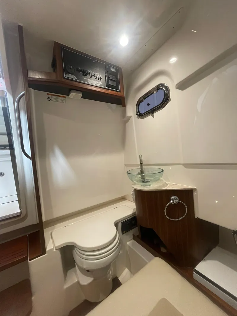 Slide: The Image of 2019 Pursuit S 328 Sport boat interior with toilet and sink. - 52