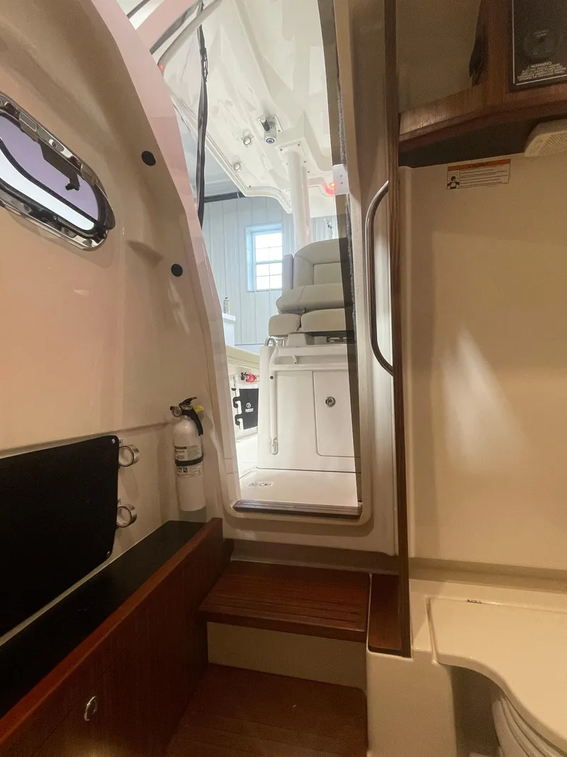 Slide: The Image of Interior view of 2019 Pursuit S 328 Sport boat, featuring seating and cabin details. - 54
