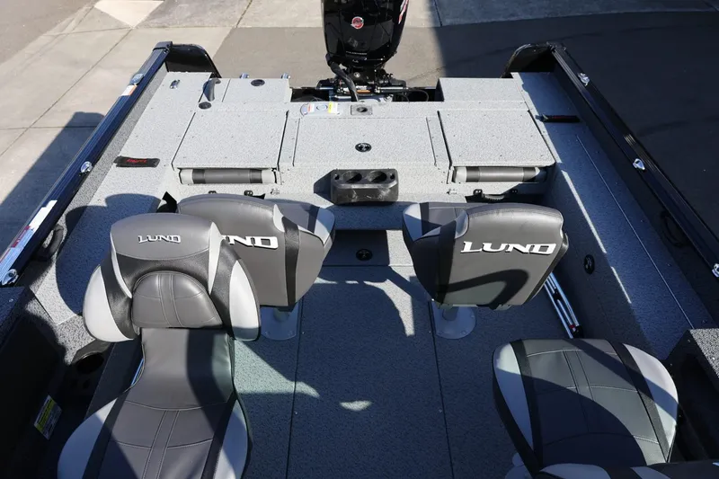 Slide: The Image of 2025 Lund 1875 Impact XS Sport boat interior with seating and storage compartments. - 11