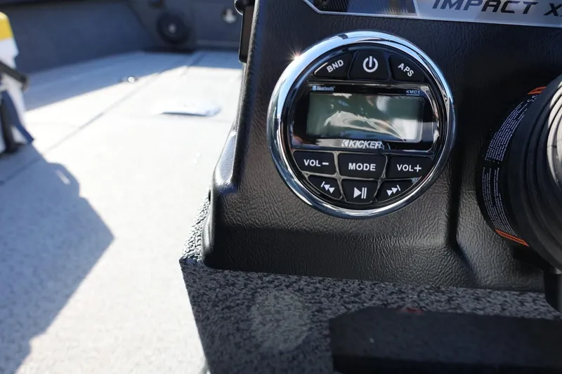 Slide: The Image of 2025 Lund 1875 Impact XS Sport boat dashboard with Kicker audio controls. - 15
