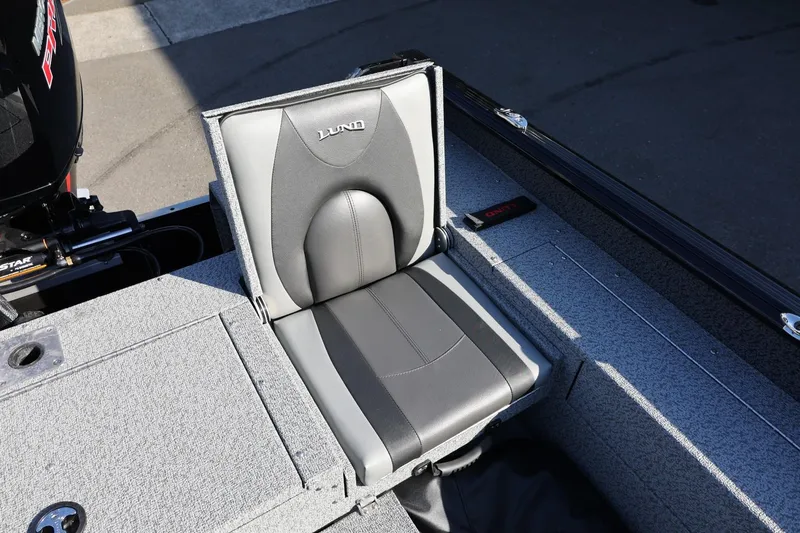 Slide: The Image of 2025 Lund 1875 Impact XS Sport boat seat, gray and black design, outdoor setting. - 17