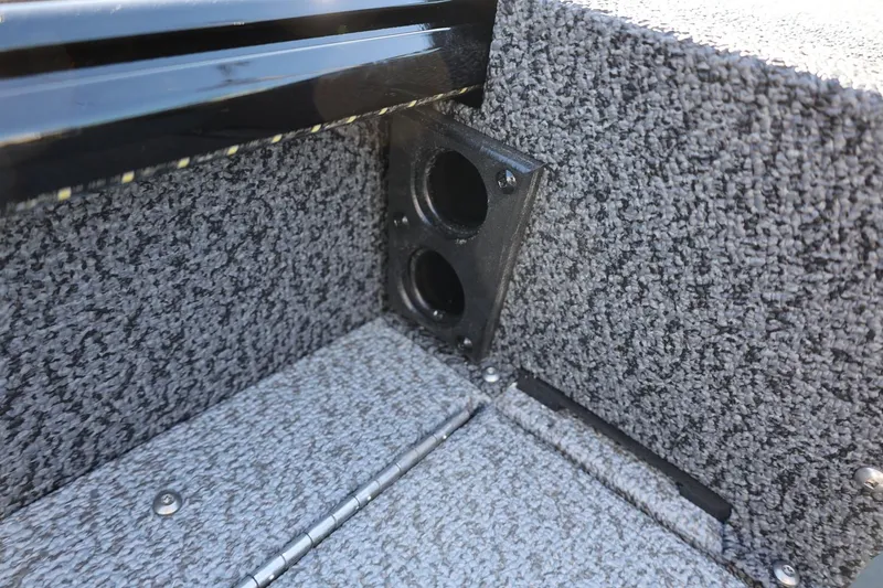 Slide: The Image of 2025 Lund 1875 Impact XS Sport boat interior with carpeted flooring and storage compartment. - 25