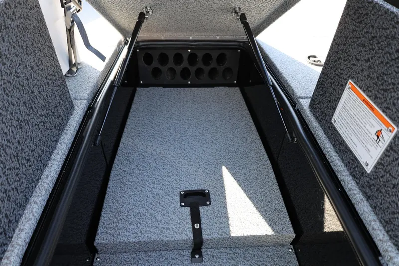 Slide: The Image of 2025 Lund 1875 Impact XS Sport boat interior storage compartment with carpeted finish. - 29