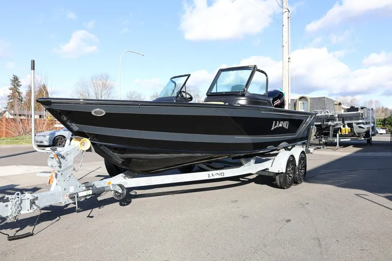Slide: The Image of 2025 Lund 1875 Impact XS Sport boat on trailer, parked outdoors. - 3