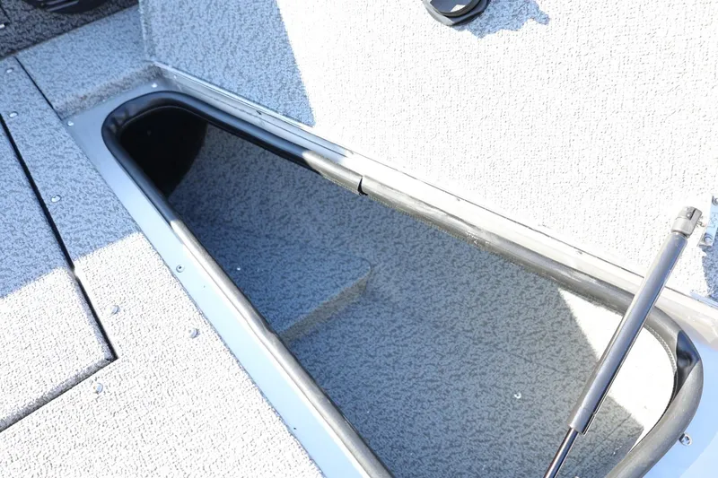 Slide: The Image of 2025 Lund 1875 Impact XS Sport boat storage compartment, open and empty. - 34