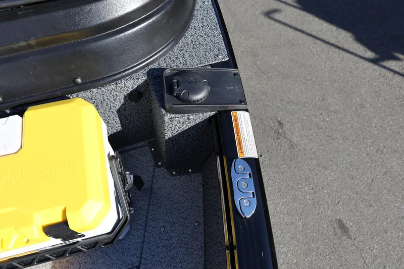 Slide: The Image of 2025 Lund 1875 Impact XS Sport boat interior with yellow storage box and control panel. - 37