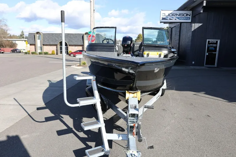 Slide: The Image of 2025 Lund 1875 Impact XS Sport boat on trailer at dealership. - 4