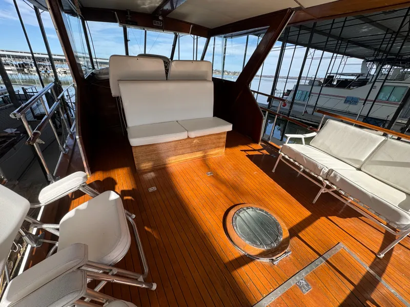 Slide: The Image of 1964 Chris-Craft Roamer 46 yacht interior with wooden deck and white seating. - 11