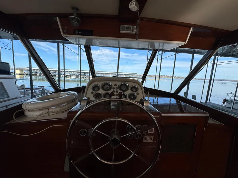 Slide: The Image of 1964 Chris-Craft Roamer 46 helm with classic wooden dashboard and steering wheel. - 16