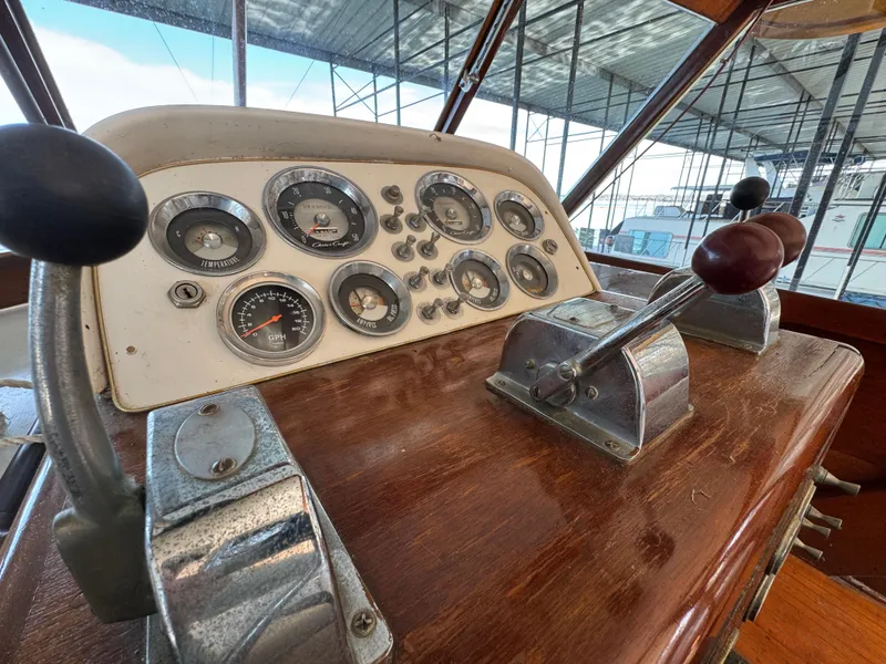 Slide: The Image of 1964 Chris-Craft Roamer 46 dashboard with vintage gauges and controls. - 17
