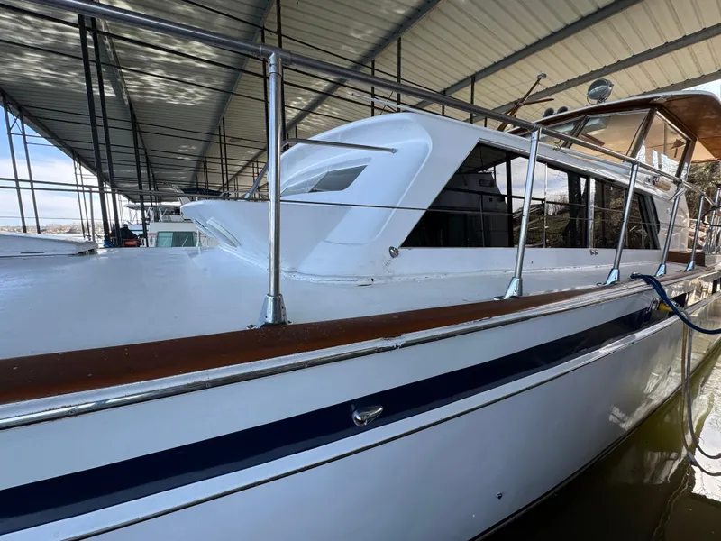 Slide: The Image of 1964 Chris-Craft Roamer 46 boat docked under a covered marina. - 2