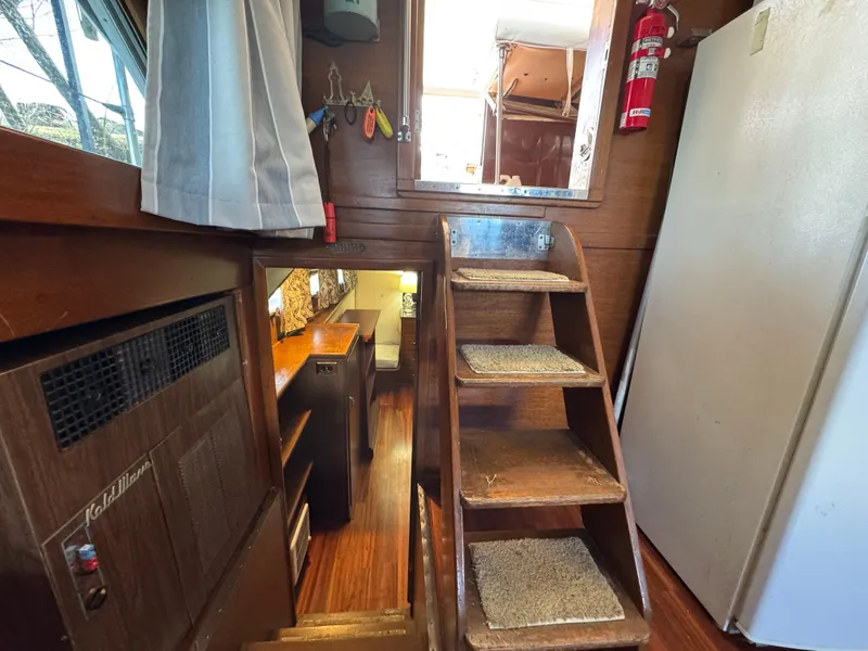 Slide: The Image of Interior of 1964 Chris-Craft Roamer 46 with wooden stairs and cozy cabin space. - 20