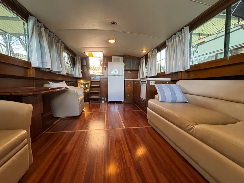 Slide: The Image of Interior of 1964 Chris-Craft Roamer 46 yacht with wood flooring and comfortable seating. - 22