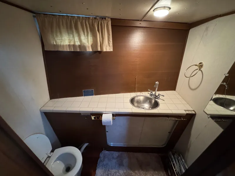 Slide: The Image of Bathroom interior of 1964 Chris-Craft Roamer 46 yacht with sink and toilet. - 24