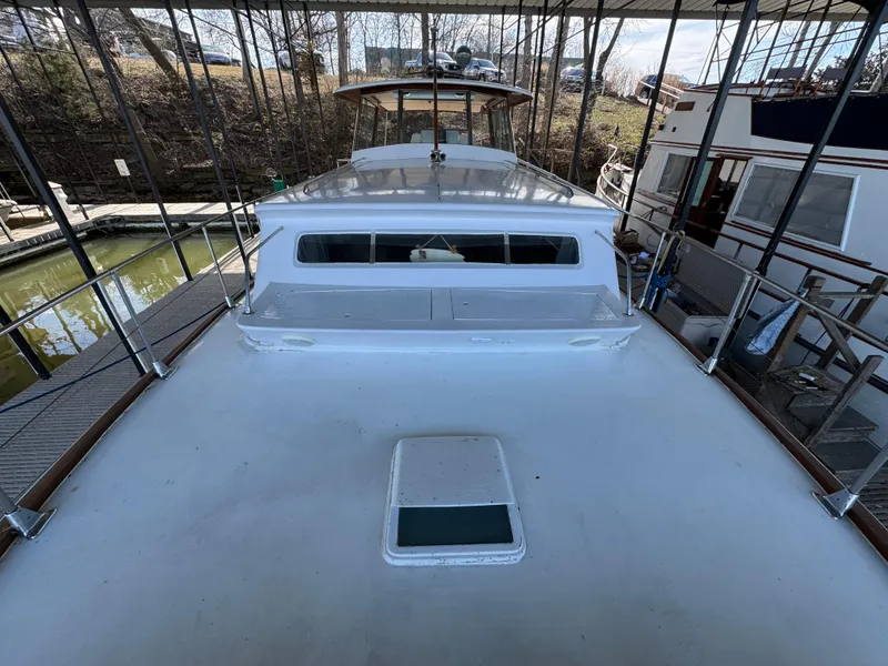 Slide: The Image of 1964 Chris-Craft Roamer 46 yacht docked, showcasing sleek design and classic craftsmanship. - 6