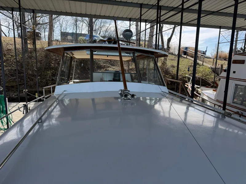 Slide: The Image of 1964 Chris-Craft Roamer 46 yacht docked under a covered marina. - 8
