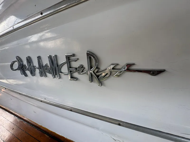 Slide: The Image of 1964 Chris-Craft Roamer 46 boat emblem on white hull. - 9