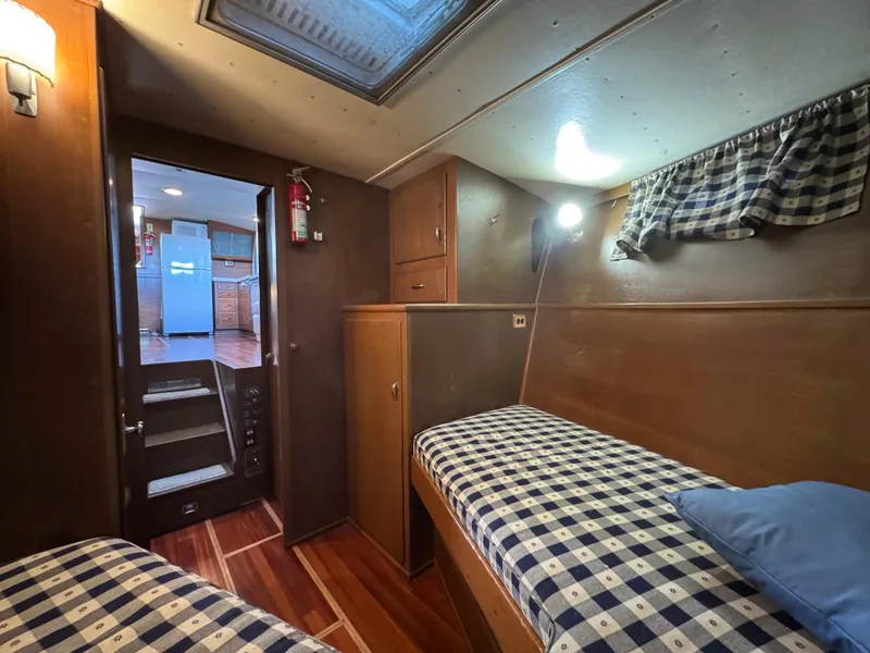Slide: The Image of 1964 Chris-Craft Roamer 46 cabin interior with twin beds and wooden furnishings. - 18
