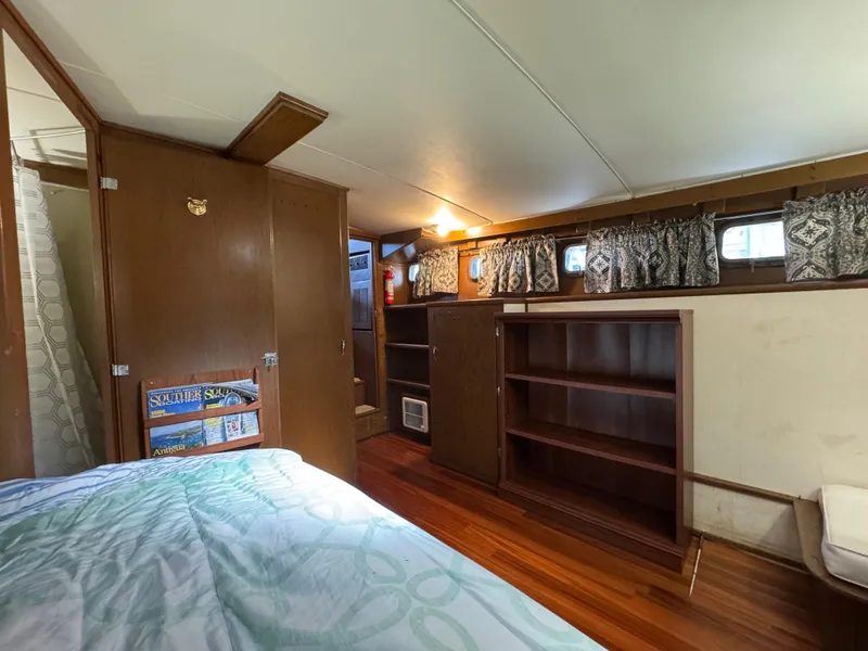 Slide: The Image of Interior of 1964 Chris-Craft Roamer 46 yacht with wood paneling and cozy furnishings. - 26