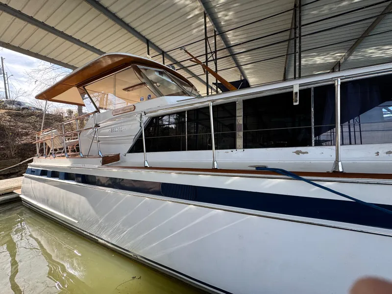 Slide: The Image of 1964 Chris-Craft Roamer 46 yacht docked under a covered marina. - 3