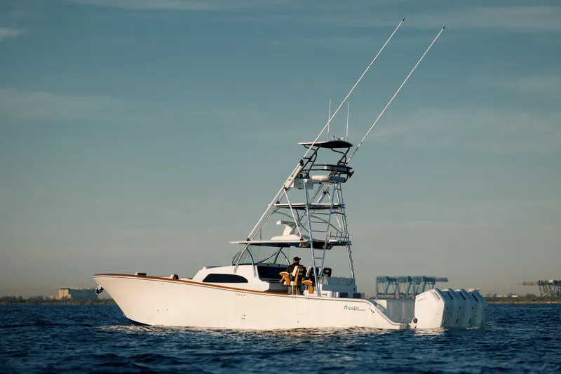 Slide: The Image of 2023 Front Runner 47 boat on open water with fishing tower and multiple engines. - 2