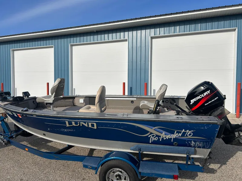 Slide: The Image of 2002 Lund Pro Angler 16 boat with Mercury engine, parked on trailer. - 10