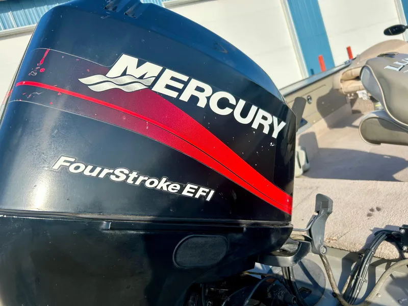 Slide: The Image of Mercury FourStroke EFI engine on a 2002 Lund Pro Angler 16 boat. - 3